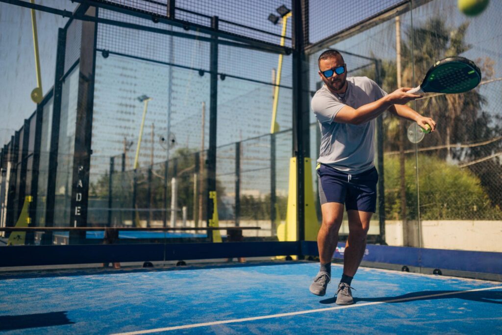 Athlete playing padddle tennis, the combination of tennis and squash